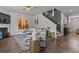 Well-lit living room with fireplace, hardwood floors, staircase and modern furnishings at 6028 Providence Dr, Union City, GA 30291