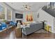 Open living room with hardwood floors, fireplace and modern furnishings, and bright windows at 6028 Providence Dr, Union City, GA 30291