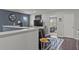 Bright living room with a dark accent wall, clock, TV, and open doorway at 6028 Providence Dr, Union City, GA 30291