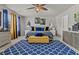 Brightly lit bedroom with a ceiling fan, an accent rug, and multiple windows at 6028 Providence Dr, Union City, GA 30291