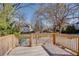 Spacious backyard features a wooden deck, lush greenery, and mature trees, offering privacy and shade at 1627 Walker Ave, College Park, GA 30337