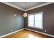 Dining room boasts bright window, hardwood floors, stylish light fixture, and fresh paint at 1627 Walker Ave, College Park, GA 30337