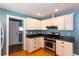 Kitchen boasts ample counter space, stainless steel appliances and white cabinets at 1627 Walker Ave, College Park, GA 30337