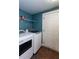 Laundry room features washer, dryer, shelving, and a white door at 1627 Walker Ave, College Park, GA 30337