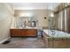 Elegant bathroom showcasing a soaking tub with decorative tile and wood cabinets at 2605 Jacobean Rd, Acworth, GA 30101