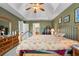 Comfortable bedroom featuring tray ceilings, ceiling fan, and decorative furniture at 2605 Jacobean Rd, Acworth, GA 30101