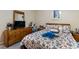 Well-lit bedroom with a comfortable bed, wooden dresser, and a decorative accent pillow at 2605 Jacobean Rd, Acworth, GA 30101