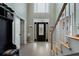 Elegant foyer with a decorative glass front door, light hardwood floors, and an open staircase at 2605 Jacobean Rd, Acworth, GA 30101