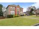 A traditional brick house with lush green lawn, manicured shrubs and inviting front porch at 2605 Jacobean Rd, Acworth, GA 30101