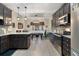 Open kitchen with granite countertops, stainless steel appliances, dark cabinetry, and a view into the dining area at 2605 Jacobean Rd, Acworth, GA 30101