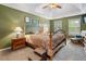 Main bedroom featuring a tray ceiling, bedside tables, and relaxing armchairs at 2605 Jacobean Rd, Acworth, GA 30101