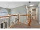 Upstairs hallway with carpeted floors, natural light, and access to a full bathroom at 2605 Jacobean Rd, Acworth, GA 30101