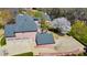 Aerial shot of the home featuring a multi-car garage, back patio, and mature landscaping on a sunny day at 4073 Hickory Fairway Dr, Woodstock, GA 30188