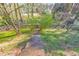 View of the backyard featuring a wooden pathway leading into the trees, fenced in for privacy at 4073 Hickory Fairway Dr, Woodstock, GA 30188