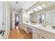 Bathroom featuring marble double vanity sinks, a large mirror, and access to another room at 4073 Hickory Fairway Dr, Woodstock, GA 30188