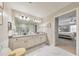 Bright bathroom with granite countertop sink and view to primary bedroom at 4073 Hickory Fairway Dr, Woodstock, GA 30188
