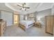 Spacious main bedroom suite features a tray ceiling and an ensuite bathroom at 4073 Hickory Fairway Dr, Woodstock, GA 30188