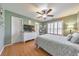 Bedroom featuring hardwood floors, shuttered windows, white dresser, and ceiling fan at 4073 Hickory Fairway Dr, Woodstock, GA 30188