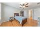Cozy bedroom featuring wood floors, ceiling fan, and a window with plantation shutters at 4073 Hickory Fairway Dr, Woodstock, GA 30188