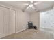 Carpeted bedroom featuring a ceiling fan, ample closet space, and neutral colors at 4073 Hickory Fairway Dr, Woodstock, GA 30188