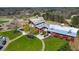 Aerial shot of a charming clubhouse with well-manicured lawns and golf carts at 4073 Hickory Fairway Dr, Woodstock, GA 30188