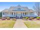 Inviting community clubhouse featuring a wide porch and manicured landscaping at 4073 Hickory Fairway Dr, Woodstock, GA 30188