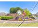 Beautiful stone community entrance with vibrant flowers and an American flag at 4073 Hickory Fairway Dr, Woodstock, GA 30188