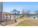 Community pool area with playground, covered patio, and lounging areas at 4073 Hickory Fairway Dr, Woodstock, GA 30188