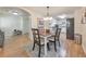 Light-filled dining room features hardwood floors and opens to a modern kitchen at 4073 Hickory Fairway Dr, Woodstock, GA 30188