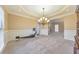 Dining room with tray ceiling, recessed lighting, carpet, and a cabinet for storage at 4073 Hickory Fairway Dr, Woodstock, GA 30188