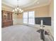 Dining room with large chandelier, molding on the walls, and a cabinet for storage at 4073 Hickory Fairway Dr, Woodstock, GA 30188