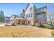 Rear exterior showcasing multi-level deck, patio, and well-maintained lawn in a desirable neighborhood at 4073 Hickory Fairway Dr, Woodstock, GA 30188