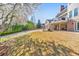 Back facade of home with second story deck, patio with seating, manicured lawn, and adjacent driveway at 4073 Hickory Fairway Dr, Woodstock, GA 30188