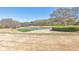 Scenic golf course view featuring a pond and lush green with golfers in the background at 4073 Hickory Fairway Dr, Woodstock, GA 30188