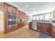 Spacious kitchen with wood floors, wood cabinets, granite counters, and stainless steel appliances at 4073 Hickory Fairway Dr, Woodstock, GA 30188