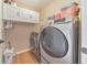A laundry room equipped with modern appliances and overhead cabinets at 4073 Hickory Fairway Dr, Woodstock, GA 30188