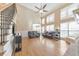 Open-concept living room with vaulted ceilings, wood floors, and lots of natural light at 4073 Hickory Fairway Dr, Woodstock, GA 30188