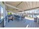 Outdoor lounge area featuring a covered patio, bar seating, and a view of the tennis courts at 4073 Hickory Fairway Dr, Woodstock, GA 30188