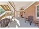 Covered patio offers comfortable outdoor living with brick accents and ceiling fan at 4073 Hickory Fairway Dr, Woodstock, GA 30188