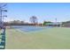 Well-maintained community tennis court with lighting and seating areas at 4073 Hickory Fairway Dr, Woodstock, GA 30188