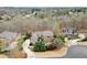 Breathtaking aerial view showcases the grand estate nestled among lush greenery and neighboring homes at 13142 Overlook Pass, Roswell, GA 30075