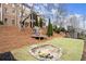 Spacious backyard with a playhouse and sand pit for creative play at 13142 Overlook Pass, Roswell, GA 30075