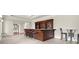 Entertainer's bar area with bar seating, dark wood cabinets, and tiled floors at 13142 Overlook Pass, Roswell, GA 30075