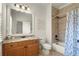 Bathroom featuring a vanity with granite counter, framed mirror, and a tiled shower/tub combo at 13142 Overlook Pass, Roswell, GA 30075