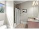 Clean bathroom featuring a shower with neutral-toned tile and a granite countertop vanity at 13142 Overlook Pass, Roswell, GA 30075