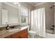 Bathroom featuring a shower-tub combination, granite counter, and wood cabinets at 13142 Overlook Pass, Roswell, GA 30075