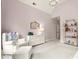 Bright Bedroom featuring soft pink walls, a chandelier, and comfortable armchair at 13142 Overlook Pass, Roswell, GA 30075