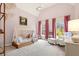 Cozy Bedroom with a charming tent bed, soft lighting, pink walls, and a comfortable armchair at 13142 Overlook Pass, Roswell, GA 30075