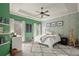 Stylish bedroom with green walls, a leaf-patterned accent wall, and a plush rug at 13142 Overlook Pass, Roswell, GA 30075