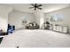 Spacious bonus room with vaulted ceilings, desk, sofa, and home gym equipment on soft carpeting at 13142 Overlook Pass, Roswell, GA 30075